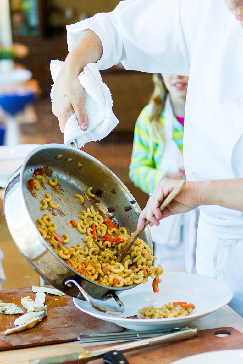 Kids learning how to cook in a cooking class.